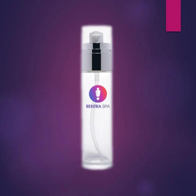 Clear glass cosmetic spray bottle with silver pump and tube on a purple background