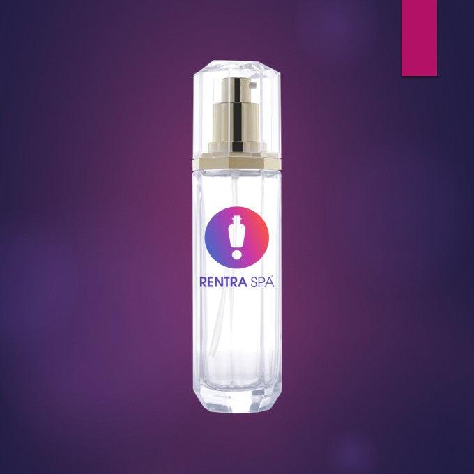 Clear cosmetic glass spray bottle with gold pump and Rentra Spa logo on purple background