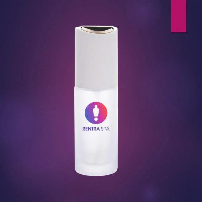 Frosted glass cosmetic pump bottle with white cap on purple background