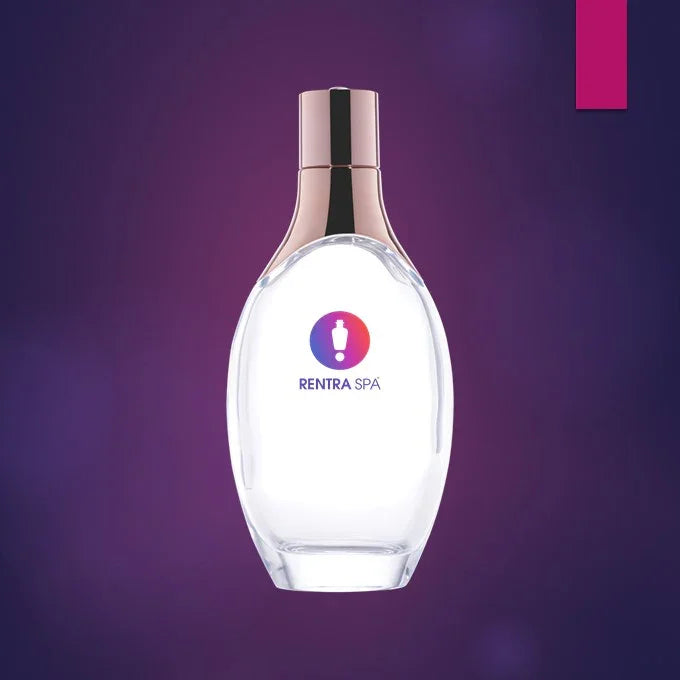 Clear glass cosmetic bottle with gold cap for beauty product packaging on purple background