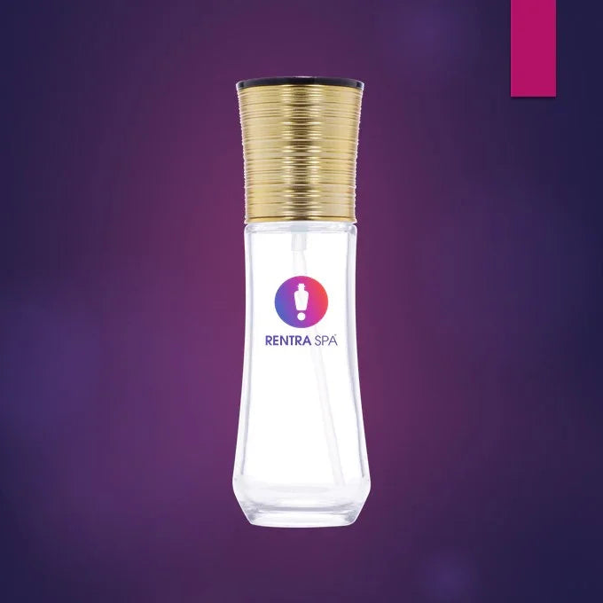 Clear glass perfume spray bottle with gold cap for cosmetic packaging on purple background