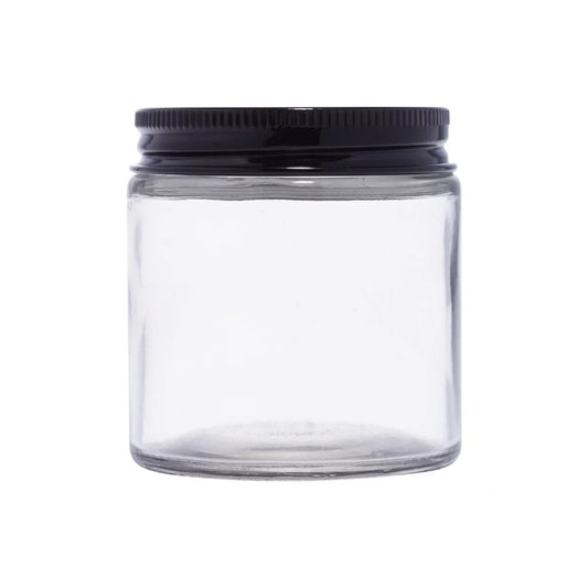 Clear round glass jar with black screw cap for cosmetic packaging