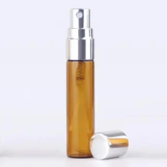 Amber glass spray bottle with silver pump, ideal for cosmetic packaging