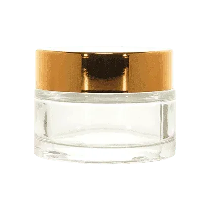 Clear cosmetic glass jar with a shiny gold screw cap, ideal for creams or skincare samples