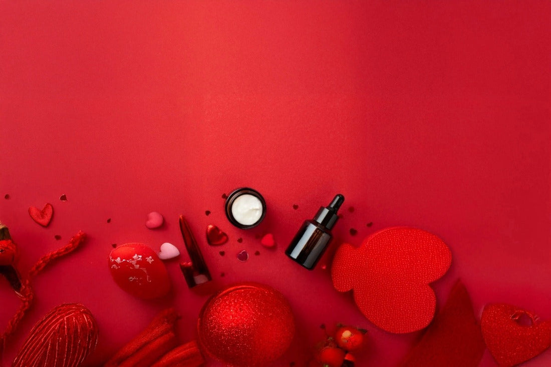 Amber cosmetic glass dropper bottle and cream jar with red decorative hearts on red background