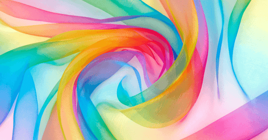 Swirling translucent fabric in vibrant rainbow colors, abstract background for design