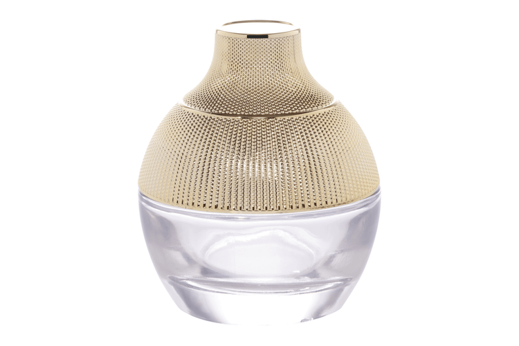 Premium cosmetic glass jar with textured gold cap, ideal for skincare packaging