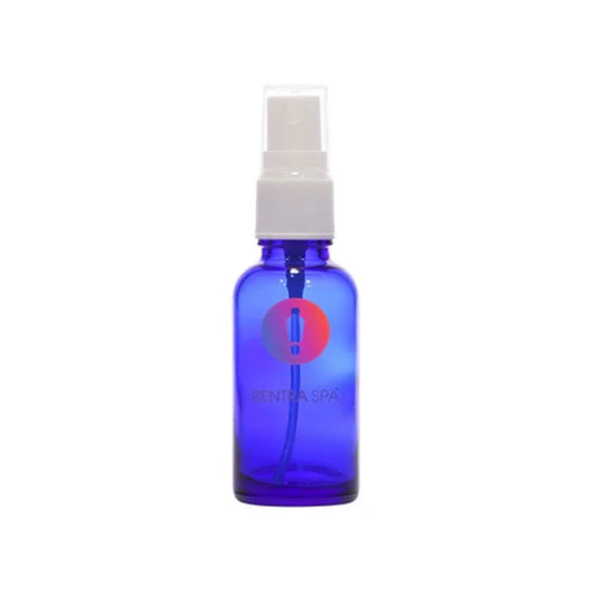 Blue glass spray bottle with white plastic nozzle for cosmetic packaging