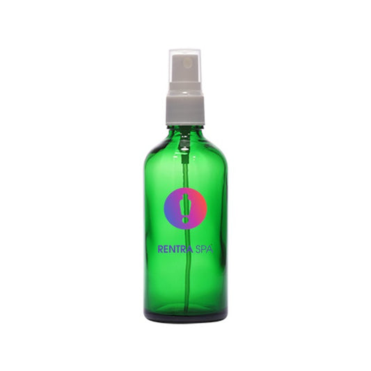 Green glass spray bottle with clear plastic pump and colorful logo, used for cosmetic packaging