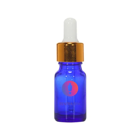 Blue glass dropper bottle with gold cap and white pipette for cosmetic packaging