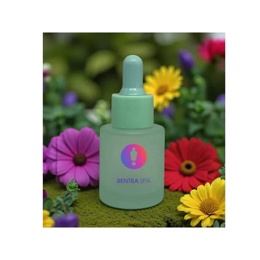 Frosted glass dropper bottle for cosmetics with mint green cap, surrounded by colorful flowers