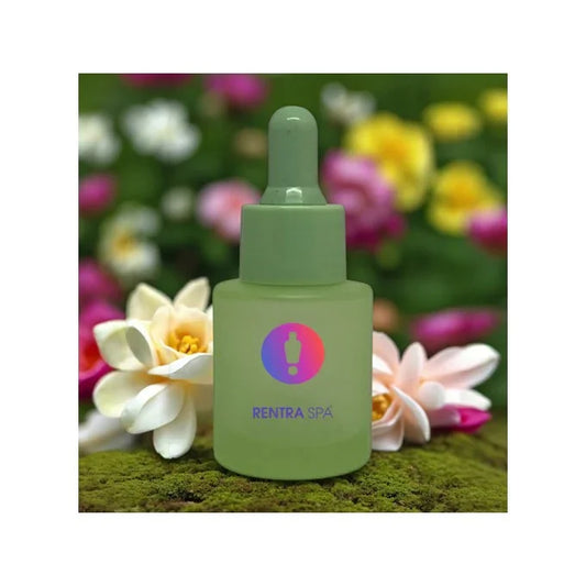 Frosted green glass dropper bottle with logo, placed on moss beside white and pink flowers.