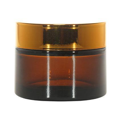 Amber glass cosmetic jar with glossy gold lid for skincare or beauty products