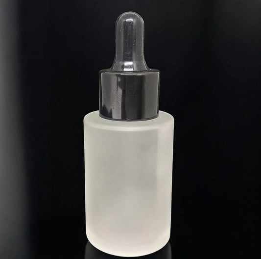 Frosted glass dropper bottle with black cap for cosmetic packaging on black background